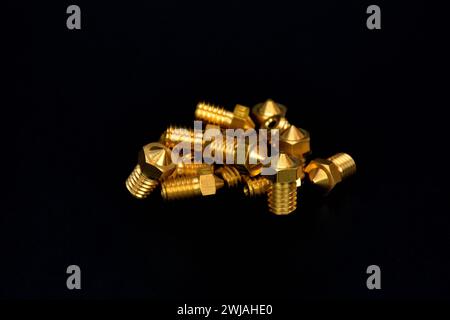 3D printer part, Brass extrusion nozzles for 3D printing machine on black background Stock Photo