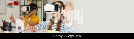 School kids wearing virtual reality headsets when studying in class Stock Photo