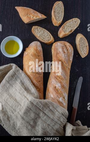 baguette bread loaves in paper bag on wooden background Stock Photo