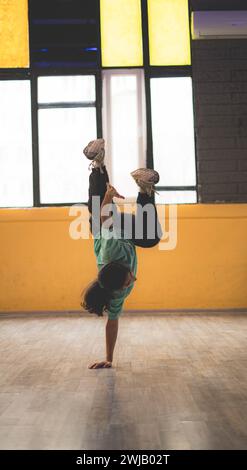A woman performing break dance in a studio Stock Photo