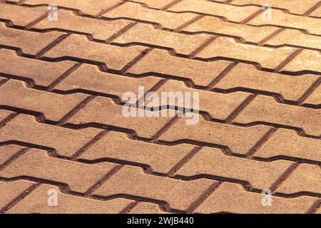Street tile. Paving slabs at sunset. Background of cobbled stones with sunbeams and sunlight. Stock Photo