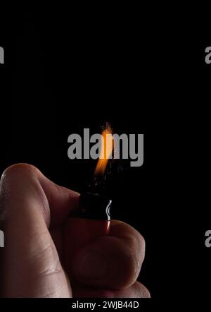 Hand with lighter igniting sparks Stock Photo