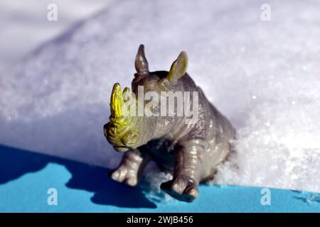 Children's toy hippopotamus shot close-up of standing with front legs on a blue background. High quality photo Stock Photo
