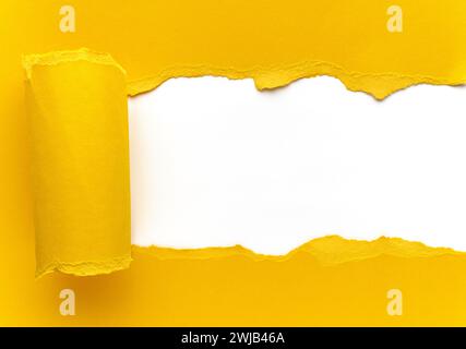 Yellow torn paper. Square shaped hole with white background. Scrap of paper. Stock Photo