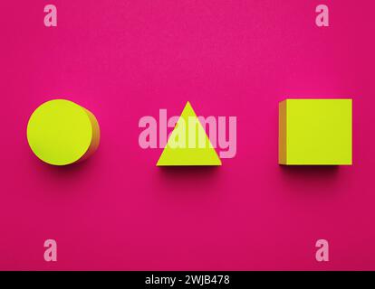 Yellow circle, triangle and square made of paper on a bright purple background. Creative futuristic concept. 3D effect. Stock Photo