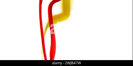 Colors dropped into liquid and photographed while in motion on white background. Color drop. Selective focus. Stock Photo