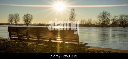 Super wide angle view of bench on the edge of high water level river IJssel boulevard of tower town Zutphen with steel draw bridge in the background Stock Photo