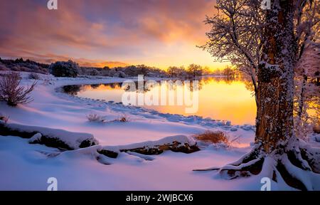 Sunset over a snow covered landscape in lowlands of Scotland. Stock Photo