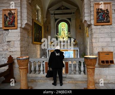 Bethlehem, West Bank. 14th Feb, 2024. A Palestinian Catholic prays during Ash Wednesday mass, the first day of Lent, in St. Catherine's Church in Bethlehem, West Bank, on Wednesday, February 14, 2024. Ash Wednesday marks the countdown to Easter with prayer, fasting and vowing devotion to God. Photo by Debbie Hill/ Credit: UPI/Alamy Live News Stock Photo