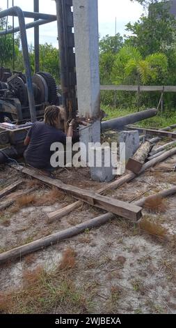 Workers is welding metal parts of concrete pile Stock Photo