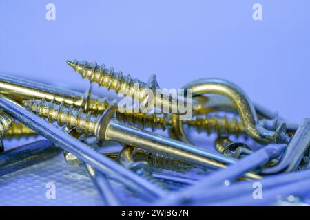 A colorful mix of nails and screws with eyelets and hoes Stock Photo