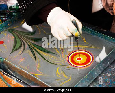 Ebru painting. Process of creating drawings in ebru technique. Drawing with paints pattern on water. Traditional Turkish art Ebru. Hobby and relaxing Stock Photo