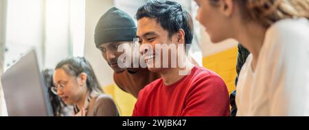 Horizontal banner or header with young co-workers multiethnic team planning a new startup - Happy computer programmers working on a new project in cre Stock Photo