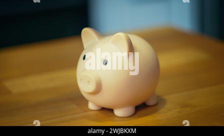 Piggy bank on a table with a soft-focus background, concept for savings and finance. Stock Photo