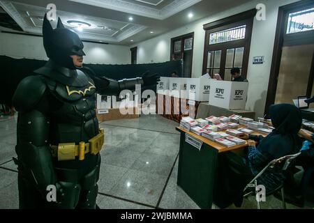 Bogor, Indonesia. 14th Feb, 2024. An election official wearing Batman superhero costume work during Indonesia presidential and legislative elections at a polling station in Bogor, Indonesia on February 14, 2024. (Photo by Andi M Ridwan/INA Photo Agency/Sipa USA) Credit: Sipa USA/Alamy Live News Stock Photo