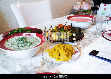 A variety of vegetarian dishes on the plates on the table. Stock Photo
