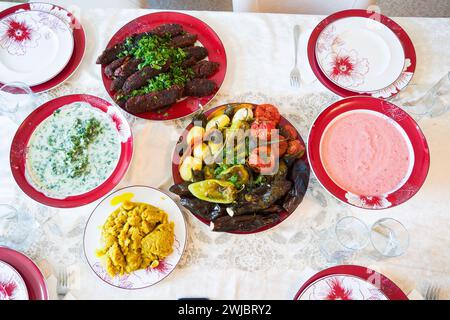 A variety of vegetarian dishes on the plates on the table. Stock Photo