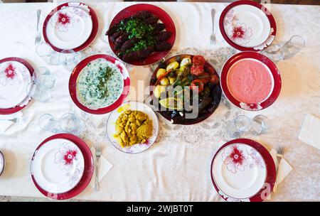 A variety of vegetarian dishes on the plates on the table. Stock Photo
