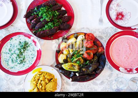 A variety of vegetarian dishes on the plates on the table. Stock Photo