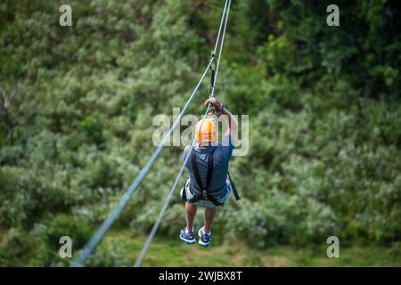 A man ziplining near Sosua in the Dominican Republic. Stock Photo
