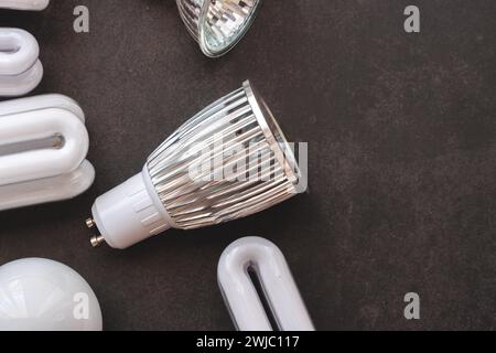 Top view of several light bulbs on top of a black table Stock Photo