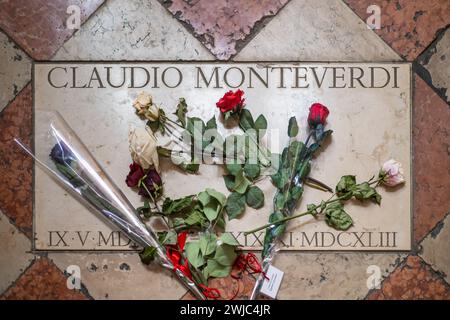 The tombstone of Claudio Monteverdi, adorned with roses, in the Santa Maria dei Frari church, Venice. Stock Photo