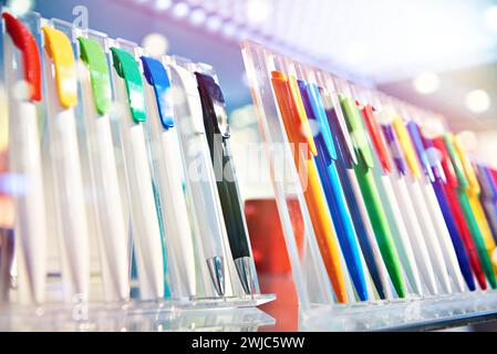 Modern colored plastic ballpoint pens on store display Stock Photo