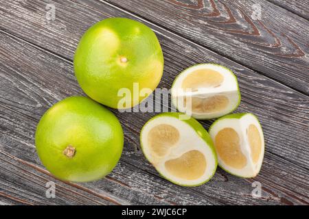 sliced sweetie on wood background top view Stock Photo