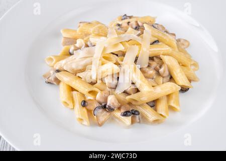 Portion of creamy garlic penne pasta with mushroom Stock Photo