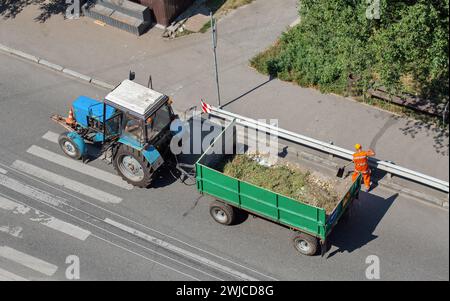 old tractor with a trailer for cleaning street garbage, top view Stock Photo
