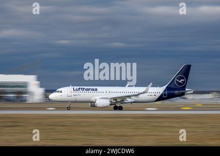 Munich, Germany - February 14. 2024 : Lufthansa Airbus A320-214 with the aircraft registration D-AIWJ is starting on the southern runway 26L of the Mu Stock Photo