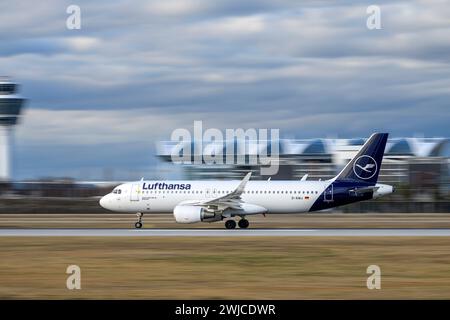 Munich, Germany - February 14. 2024 : Lufthansa Airbus A320-214 with the aircraft registration D-AIWJ is starting on the southern runway 26L of the Mu Stock Photo