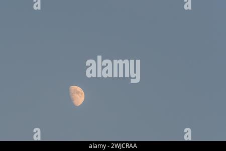 Half moon in clear, cloudless blue evening sky in South Korea Stock Photo