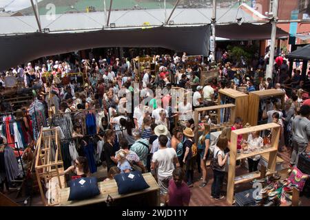 Neighbours goods market time in Capetown. Young hip people gather to enjoy live music, good food, local designer clothes and the boho vibe. Stock Photo