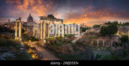 Amazing cityscape scene of the Roman Forum in Rome, Italy, at dusk, with dramatic colorful sky and clouds after sunset Stock Photo