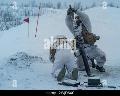 Norwegian Army soldiers with the 1st Armoured Battalion prepare to fire a 81 mm mortar while showcasing their capabilities in an arctic environment in preparation for the NATO exercise Nordic Response 2024 in Setermoen, Norway, Jan. 31, 2024. Nordic Response is a Norwegian national readiness and defense exercise designed to enhance military capabilities and allied cooperation in high-intensity warfighting in a challenging arctic environment. This exercise will test military activities ranging from the reception of allied and partner reinforcements and command and control interoperability to co Stock Photo