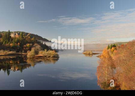 Carbisdale Castle in the trees overlooking the water of Kyle of Sutherland, Scottish Highlands, UK. Stock Photo