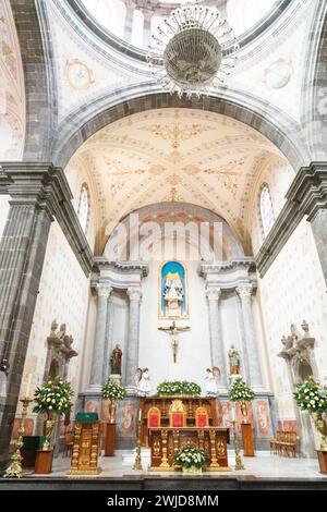 Interior view of Santa María de la Asunción parish church on Hidalgo Square in the historic district in Tequisquiapan, Querétaro, Mexico. The 16th century neoclassical style church is constructed of pink sandstone. Stock Photo