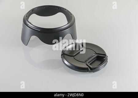 Camera lens hood and Black front lens cap on a white background photo equipment Stock Photo