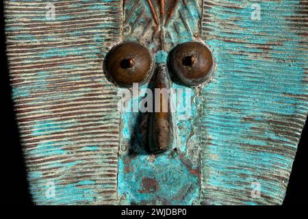 Macro shot of a wooden Kota reliquary figure from Gabon. Tribal African art, showcasing masterful craftsmanship and spiritual symbolism. Stock Photo