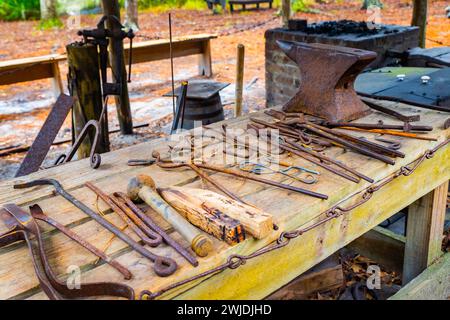 Set of vintage rusty blacksmith tools on the table outdoors Stock Photo
