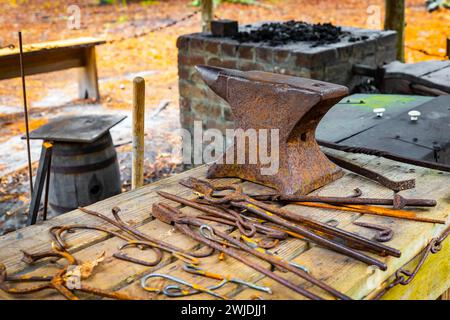 Set of vintage rusty blacksmith tools on the table outdoors Stock Photo