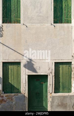 Front view of an old Italian house with windows and door Stock Photo