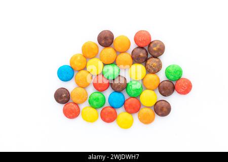 Colorful candy chocolate buttons on white isolated background Stock Photo