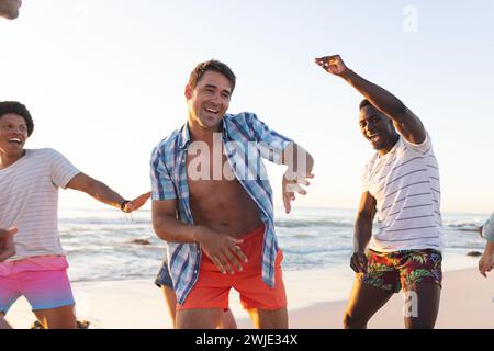 Young men enjoy a lively moment on the beach Stock Photo