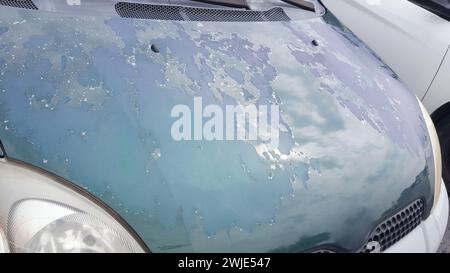 car hood with paint worn by the weather and the sun Stock Photo