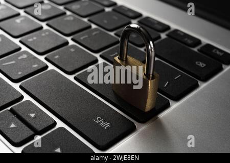 Close-up of a lock on a keyboard with an aluminum metal case. Concept for online security, protection from hackers, antivirus protection, internet acc Stock Photo