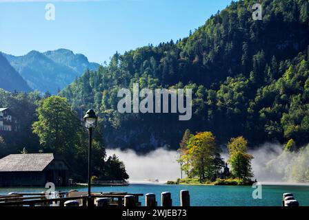 An electric-powered excursion boat emerges from the fog on Königssee, or King's Lake, Bavaria, Germany. Stock Photo