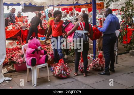 Nairobi, Kenya. 14th Feb, 2024. Kenyans shop valentine's day gifts from street vendors along Kimathi street during Valentine's Day in Nairobi. Kenyans filled various streets across the country as they celebrated Valentine's Day despite the harsh economic situation currently being experienced. Florists and gift shops spread across Nairobi city also recorded increased traffic as Kenyans seized the moment to buy gifts as well as hampers for their loved ones. Kenya is a large exporter of flowers to Europe and the Middle East. Credit: SOPA Images Limited/Alamy Live News Stock Photo