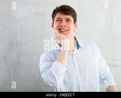 Young guy holding his cheek with toothache Stock Photo